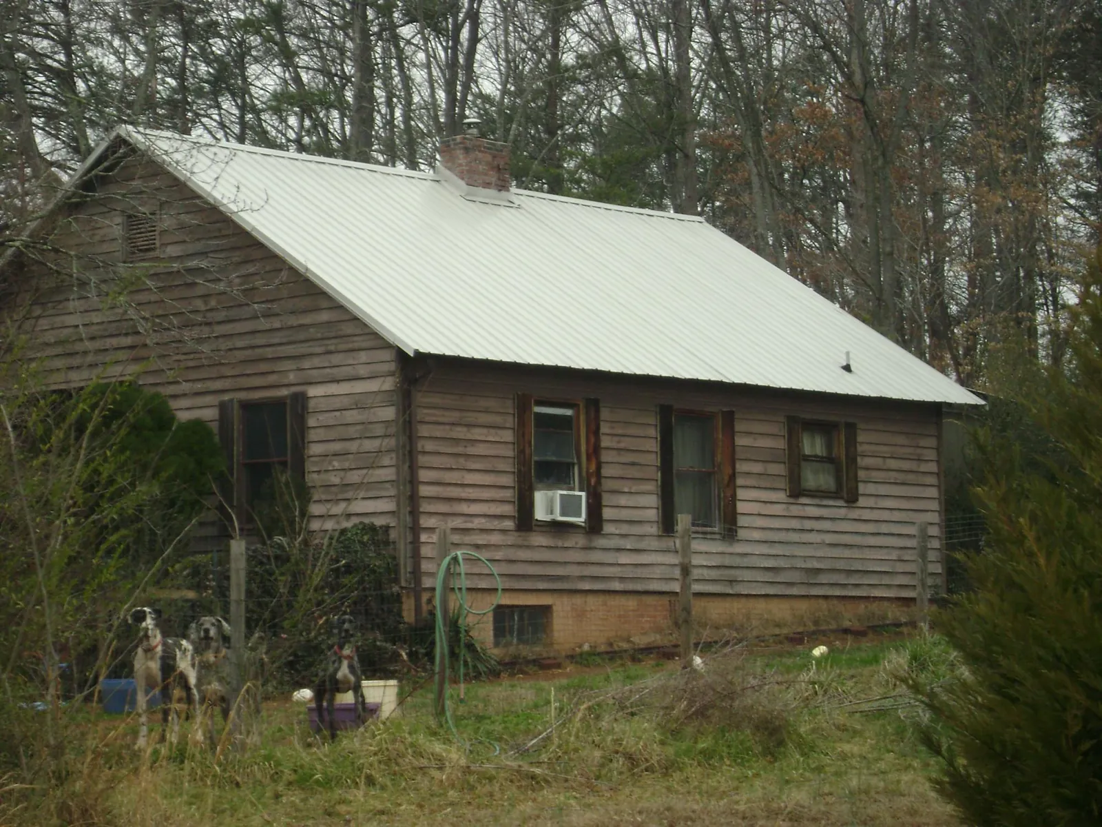 White metal roof on an old wood sided farmhouse, from a Metal Roof Installation job in Lewistown